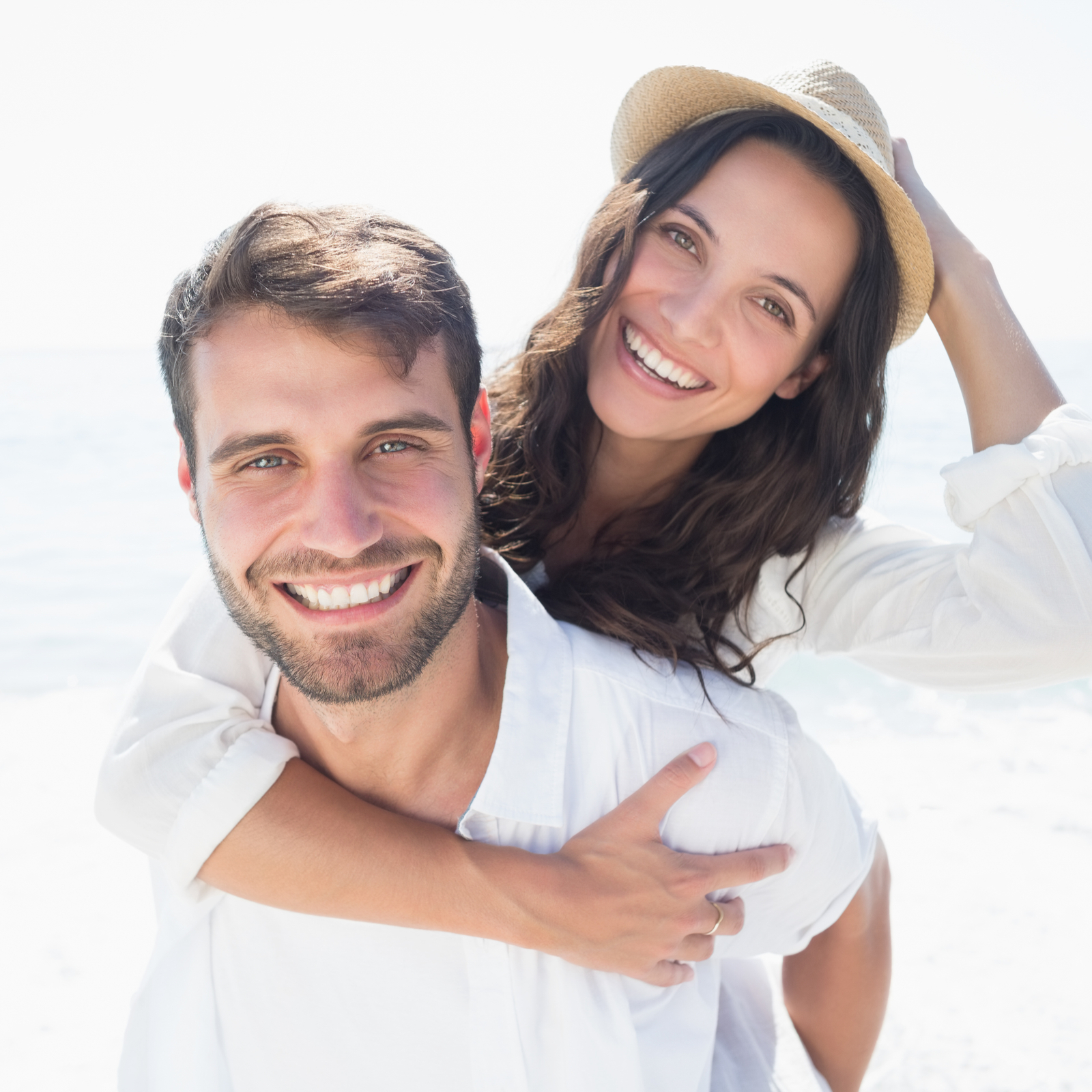 Happy couple smiling at the beach